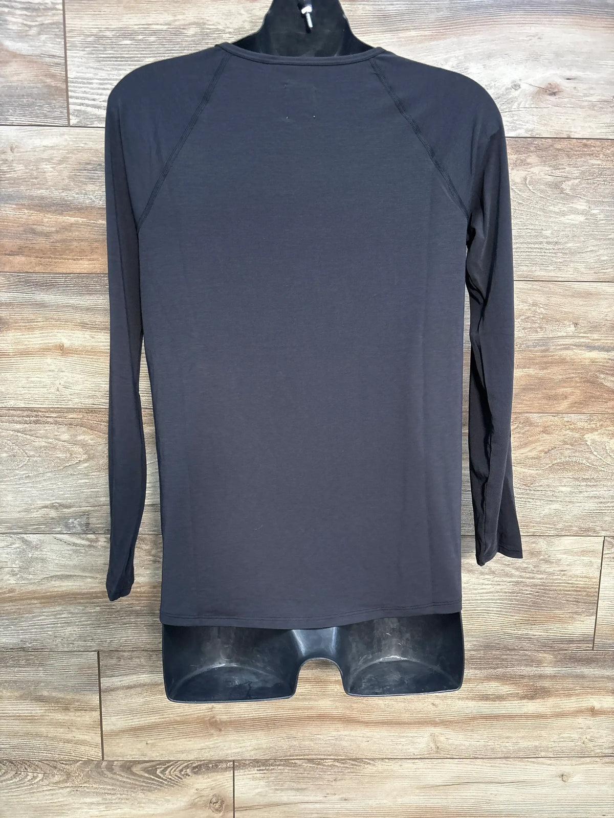 Front view of GapFit Breathe maternity T-shirt in true black with long sleeves and crewneck against wood background
