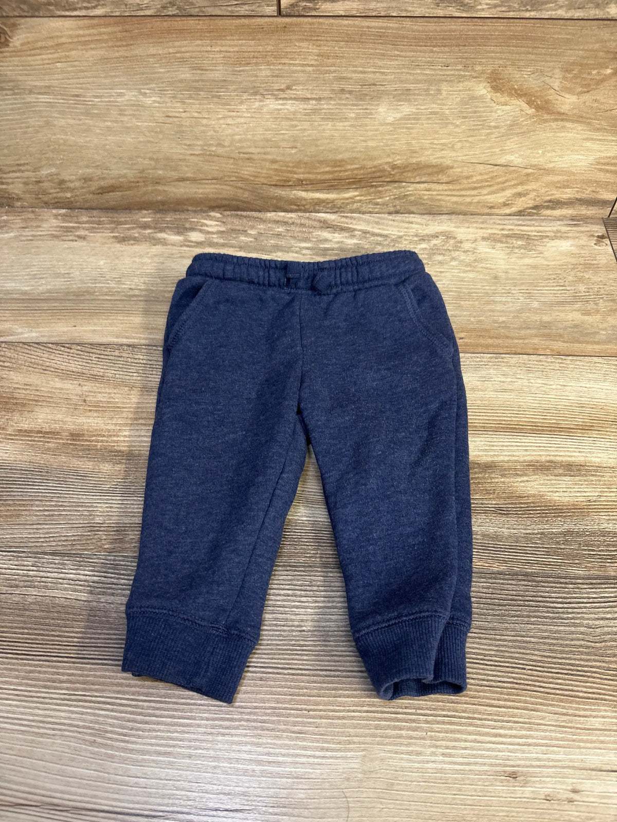 Front view of Cat and Jack drawstring joggers in size 12 months with an adjustable drawstring, side pockets, and ribbed cuffs