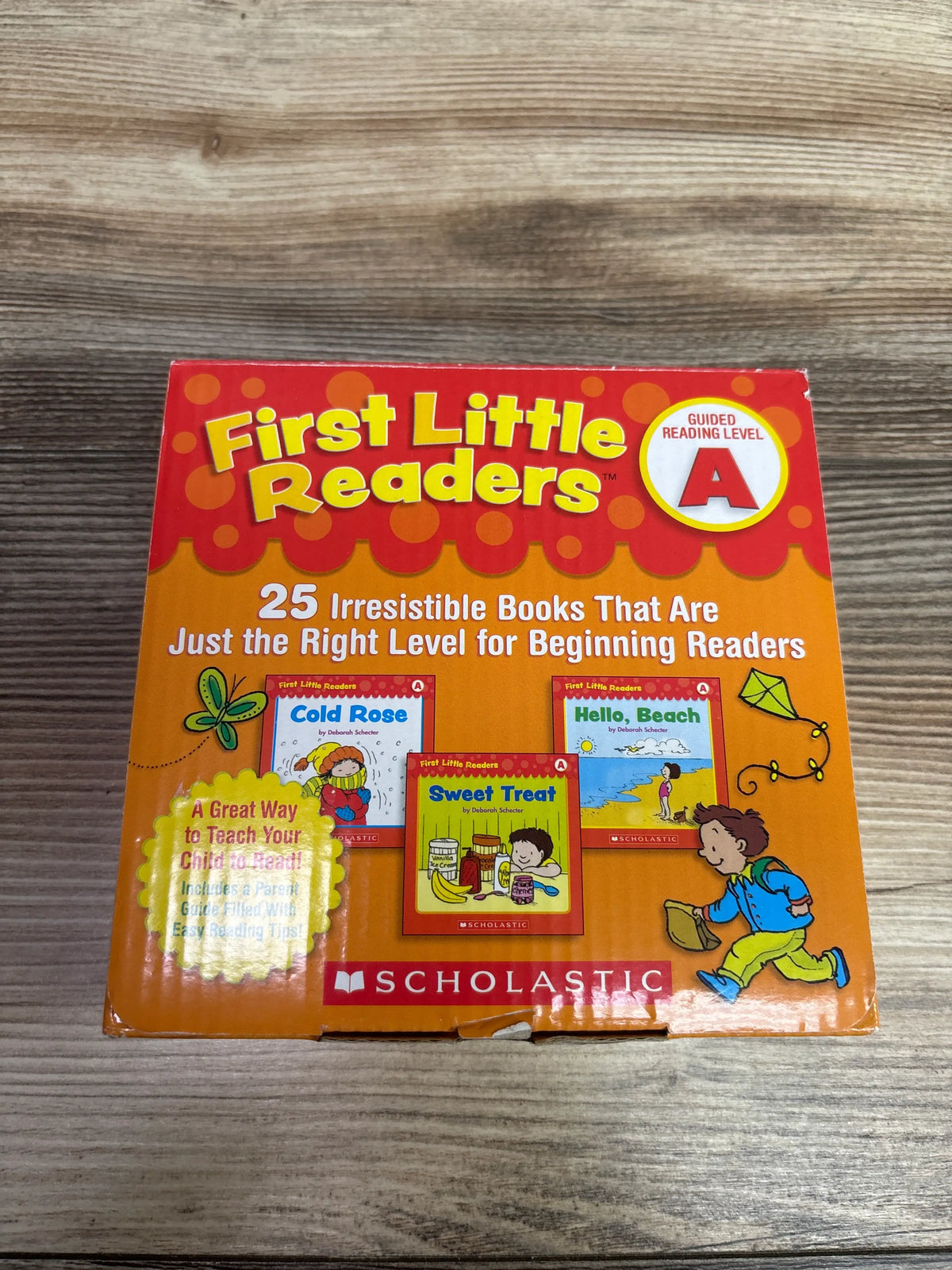 Front view of First Little Readers Guided Reading Level A paperback book set with 25 colorful books on a wood surface