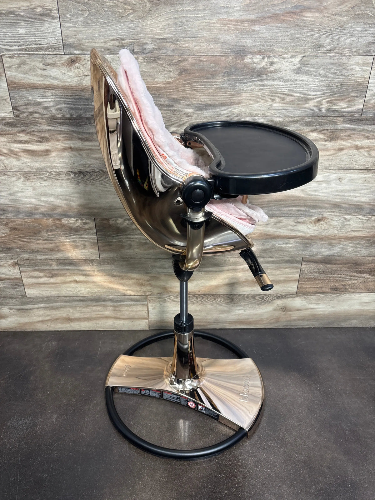 Side view of Bloom Fresco Special Edition High Chair in Rose Gold showcasing black feeding tray and pink padded seat
