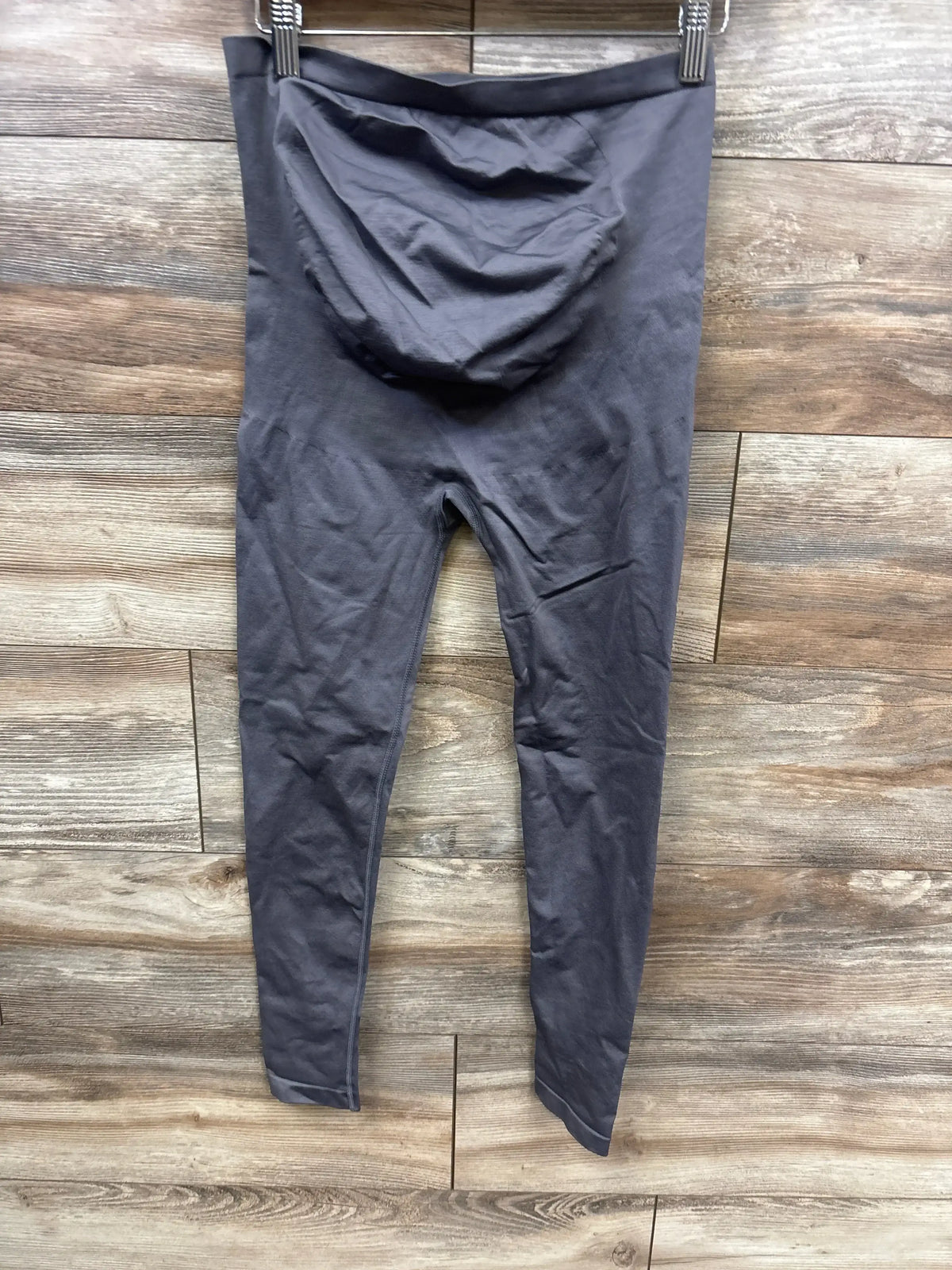 Gray maternity leggings with over-belly panel displayed on wooden floor