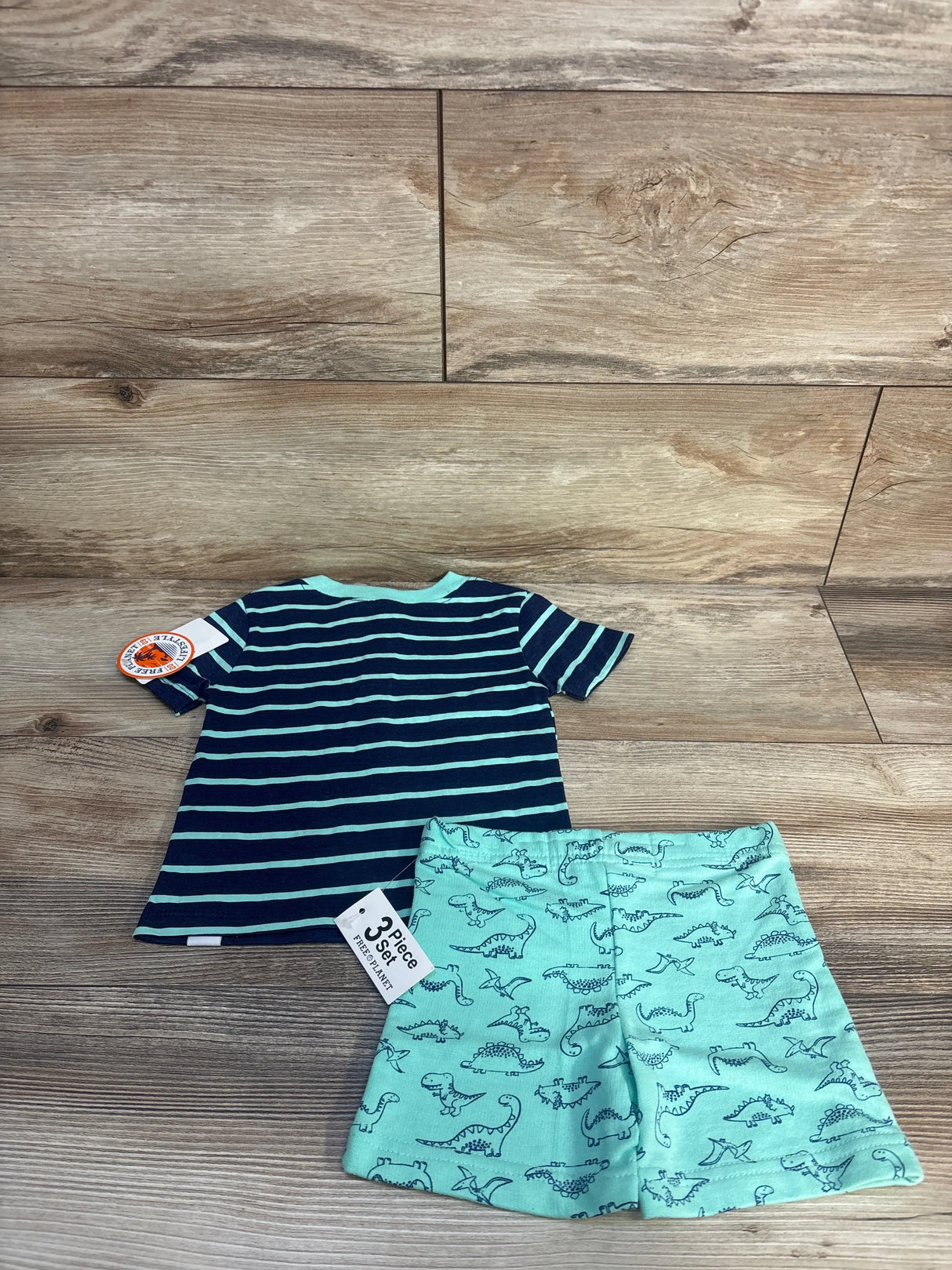 Toddler boy outfit with navy striped t-shirt and mint green dinosaur print shorts