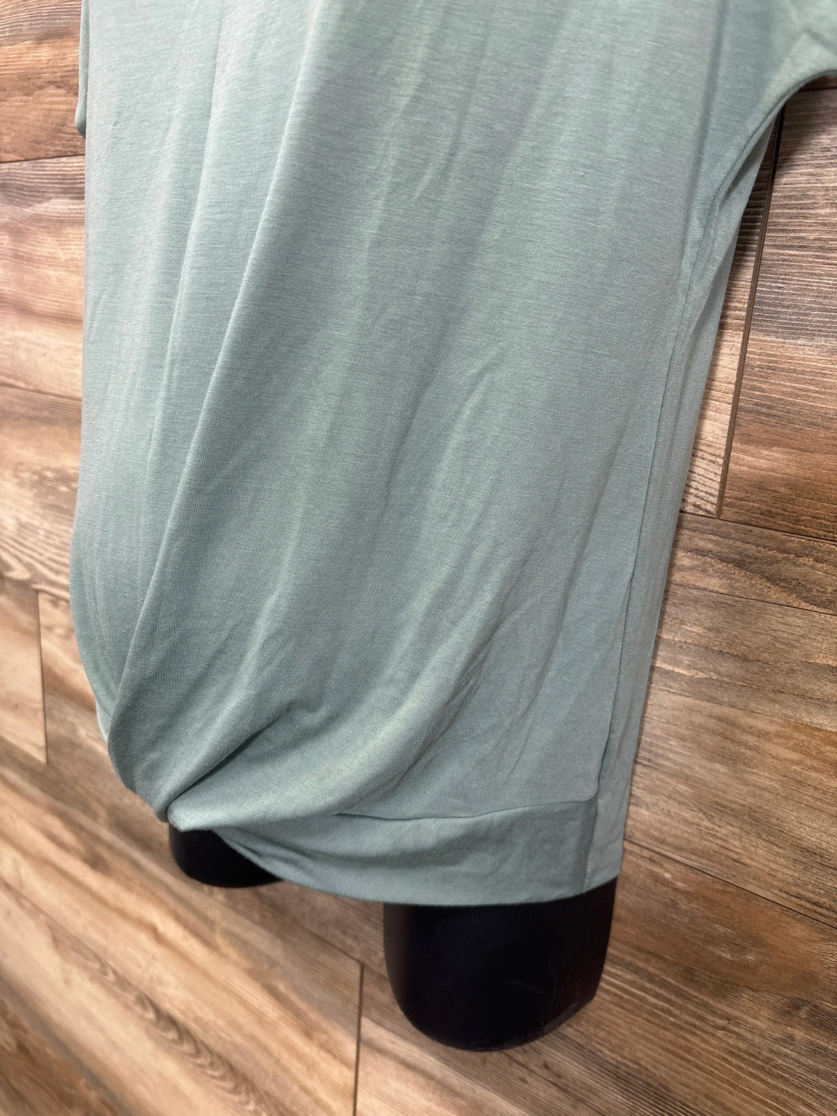 Soft mint green maternity pants on mannequin, cozy fabric for pregnancy comfort