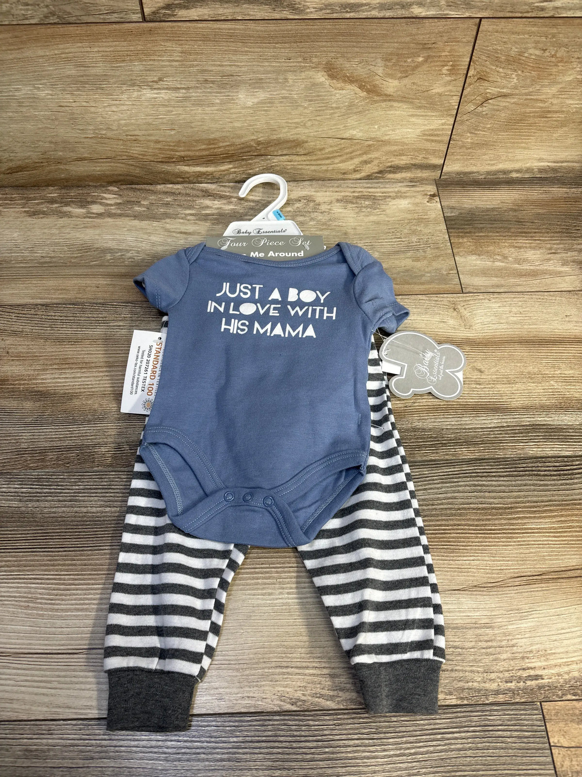 Front view of blue Baby Essentials 4pc set showing a bodysuit with Just A Boy In Love With His Mama text and striped pants