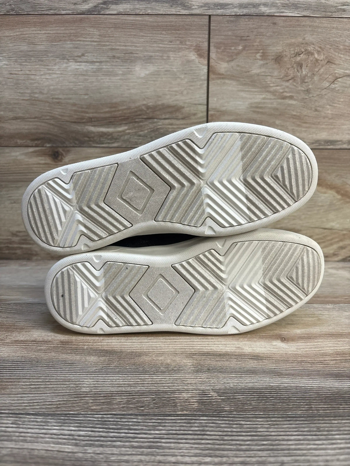 Bottom view of NEW Art Class Geoff high-top sneakers size 6Y showing white rubber soles with light wear on wood floor