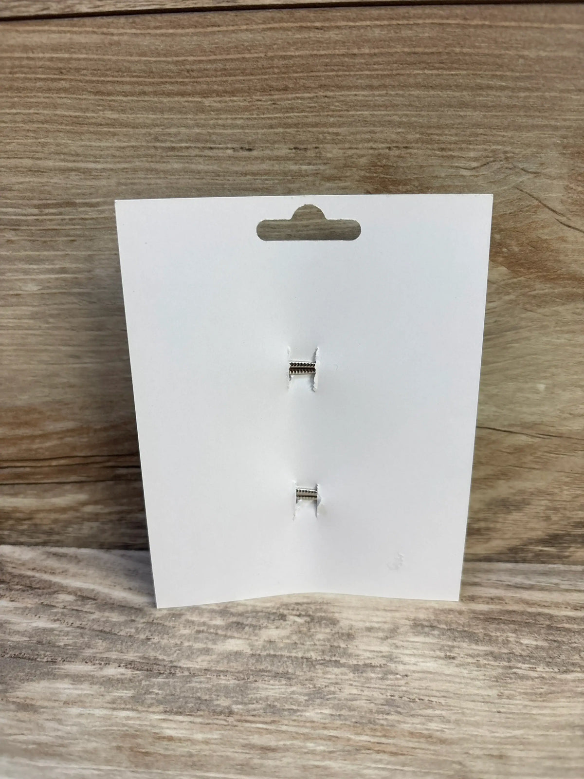 Front view of 2-pack brown hair bows backing card showing two silver alligator clips on light wood background