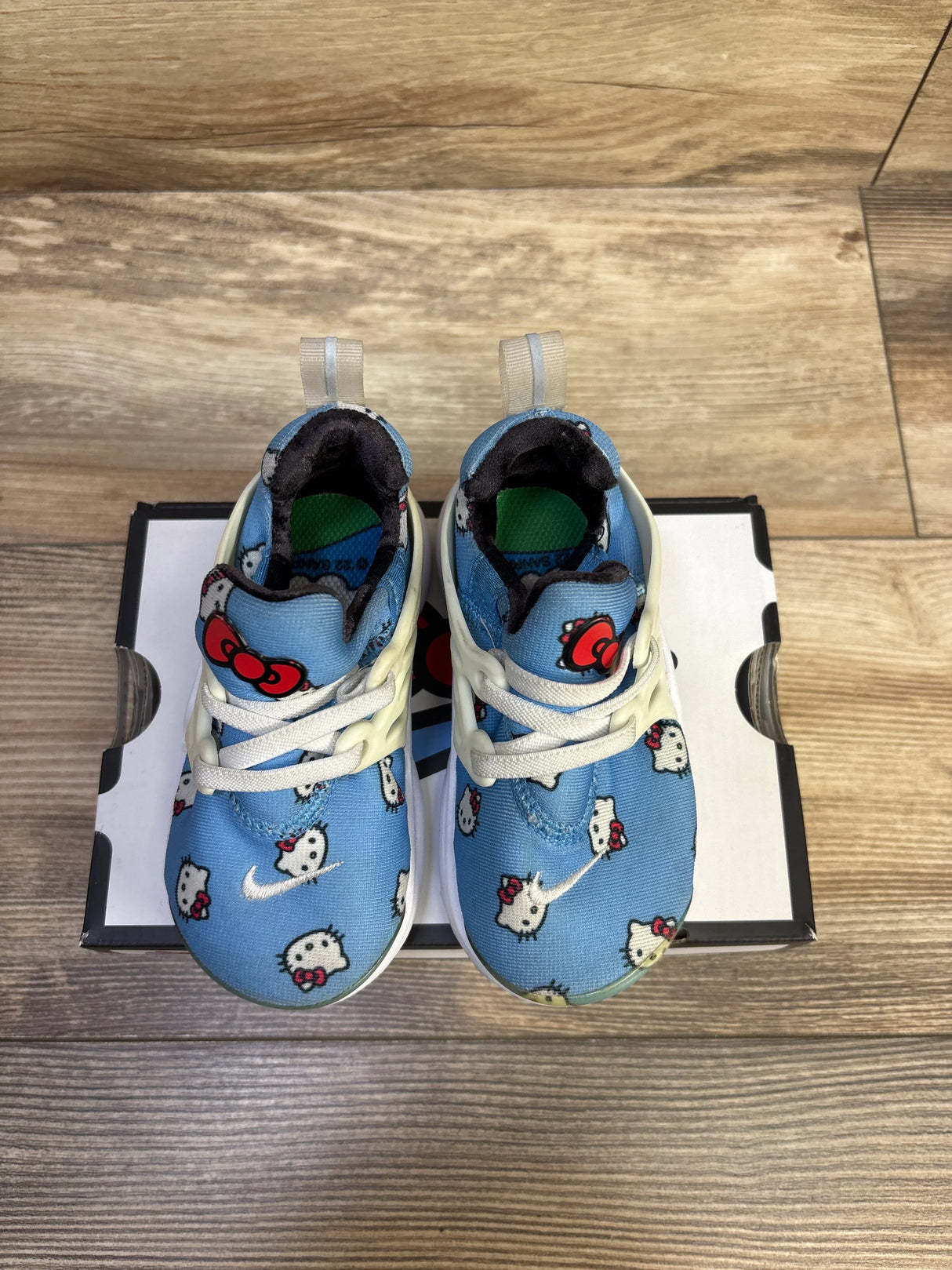 Top view of Hello Kitty x Nike Air Presto TD toddler sneakers, University Blue, size 7C, showing Hello Kitty print and lace cage