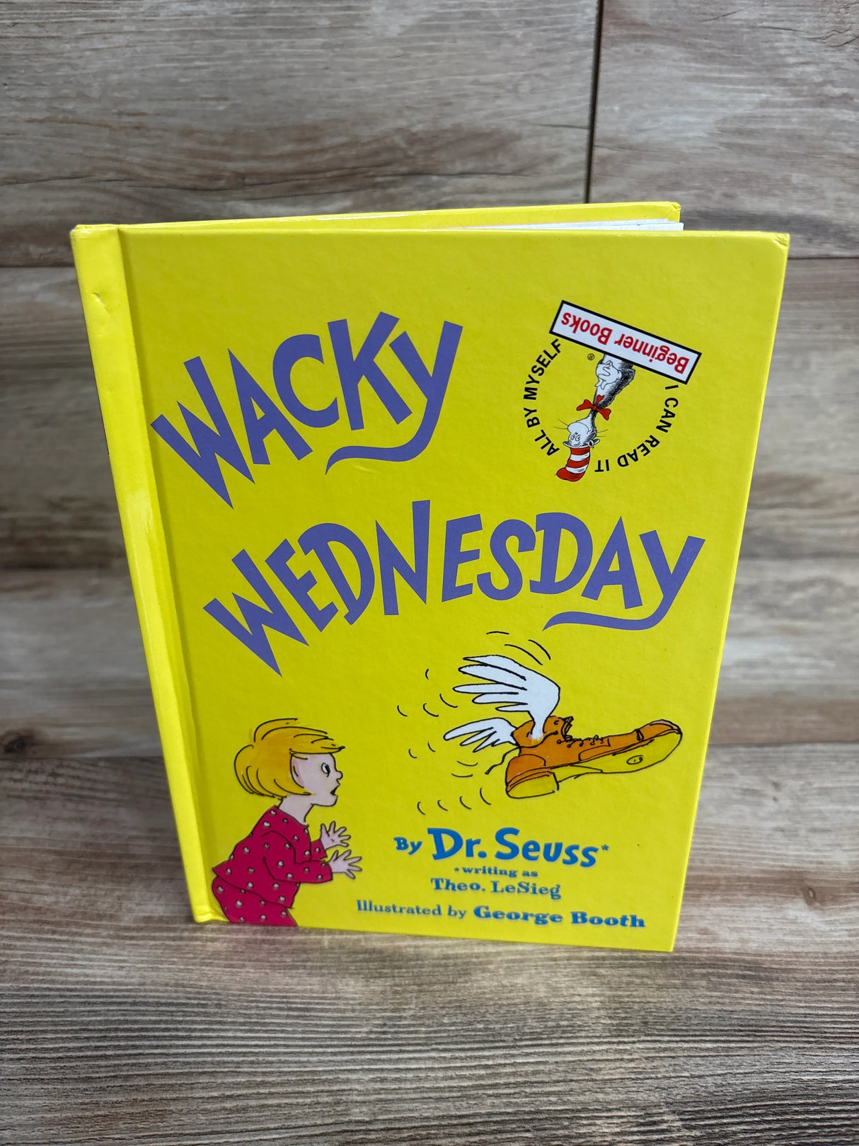 Yellow children's book titled Wacky Wednesday by Dr. Seuss with illustration of a child and winged boot