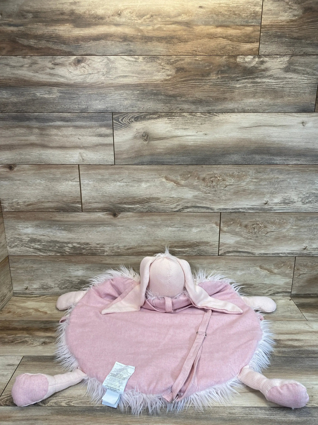 Front view of RH Baby Wooly Plush Play Mat, Petal Bunny showing round pink mat with faux-fur trim and floppy ears