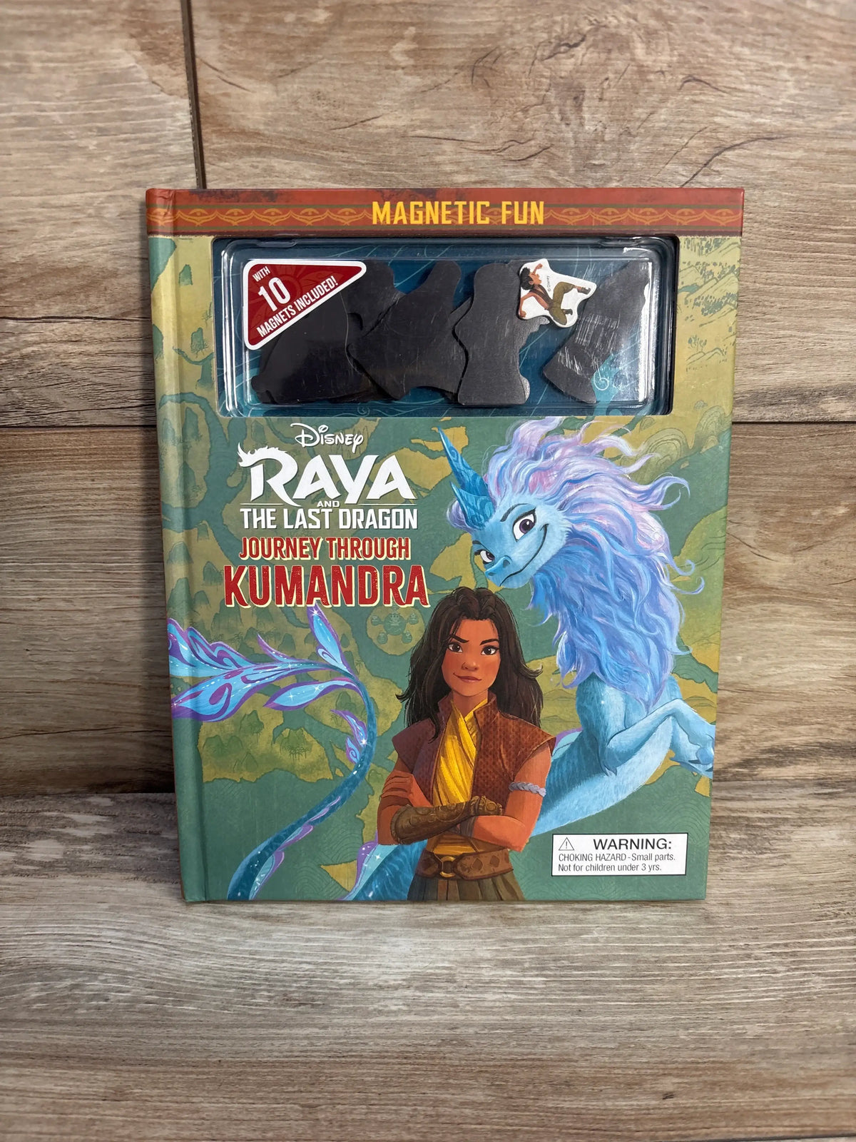 Front cover of Raya and the Last Dragon Journey Through Kumandra magnetic hardcover book showing Raya and Sisu with magnetic pieces