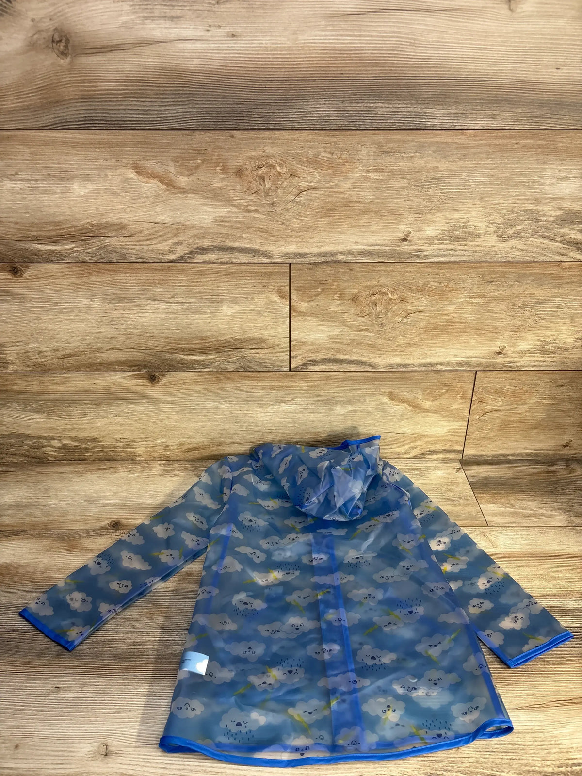 Front view of Cat & Jack blue clear rain jacket in size 5T, showcasing cloud print and hood