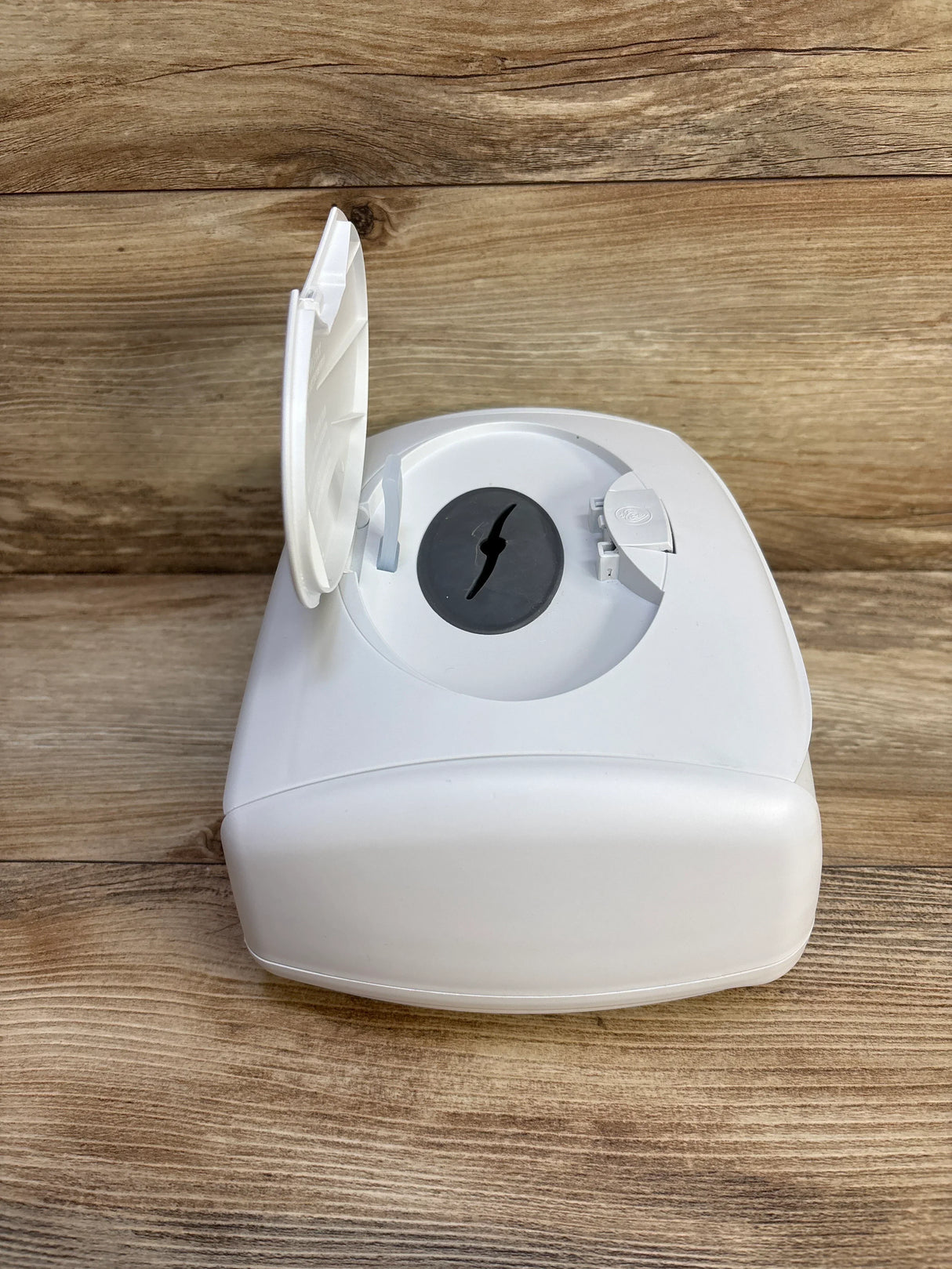 Top-front view of Prince Lionheart Ultimate Wipes Warmer showcasing open lid and black silicone dispensing seal on wood surface