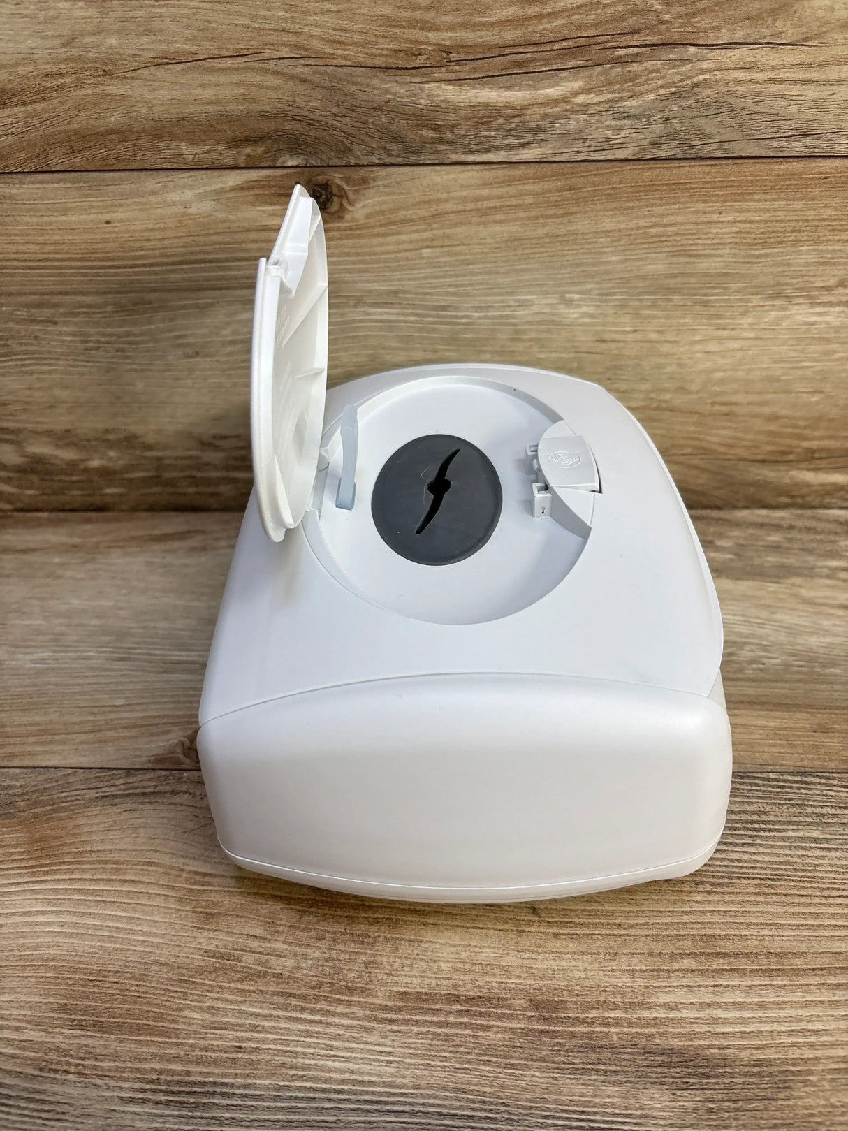Top-front view of Prince Lionheart Ultimate Wipes Warmer showcasing open lid and black silicone dispensing seal on wood surface