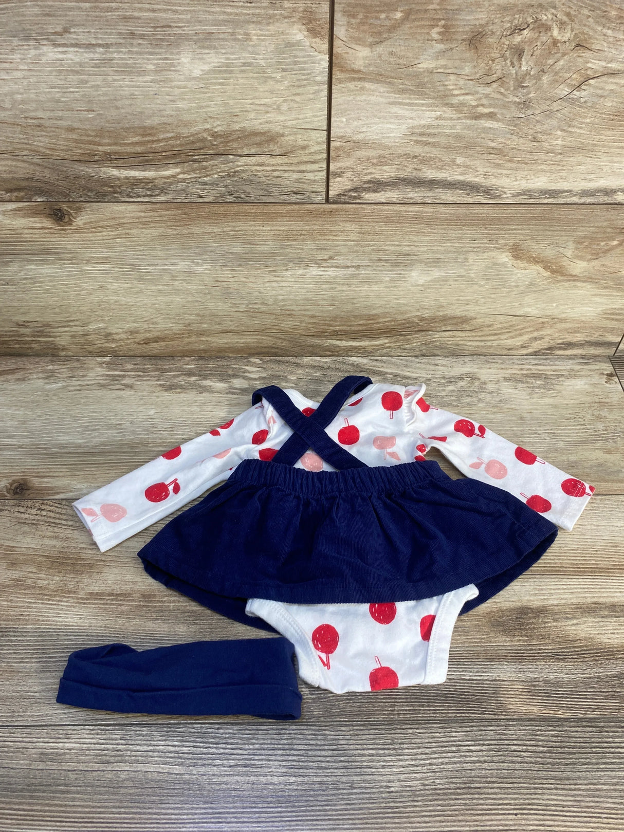 Baby girl outfit set with navy skirt, apple print bodysuit, and matching headband