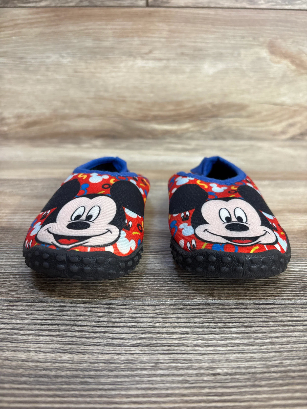 Mickey Mouse toddler shoes with non-slip soles, red blue print, kids footwear on wood floor