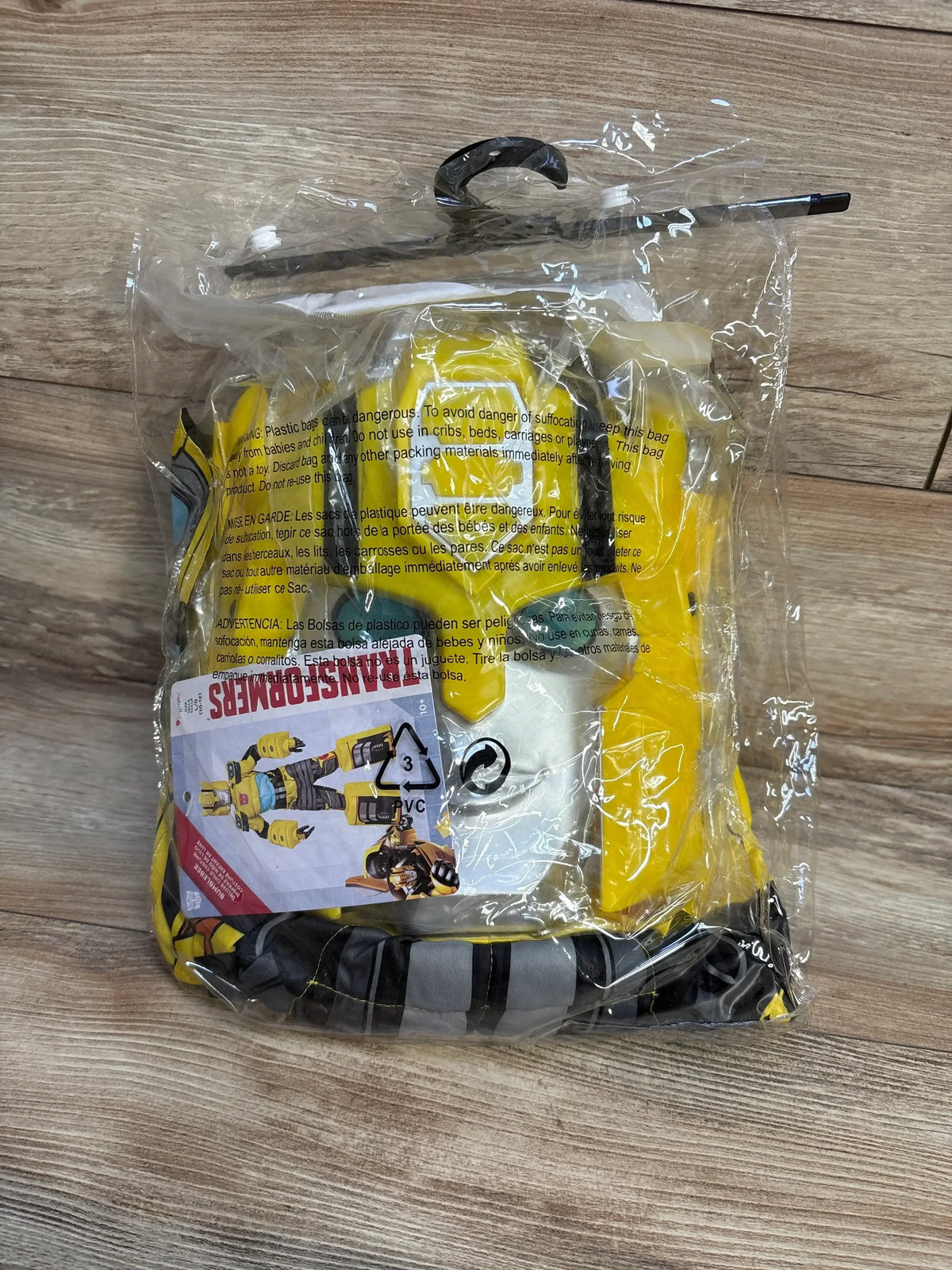 Front view of Disguise Transformers Bumble Bee costume, size 10 to 12, showcasing yellow and black pieces in clear packaging