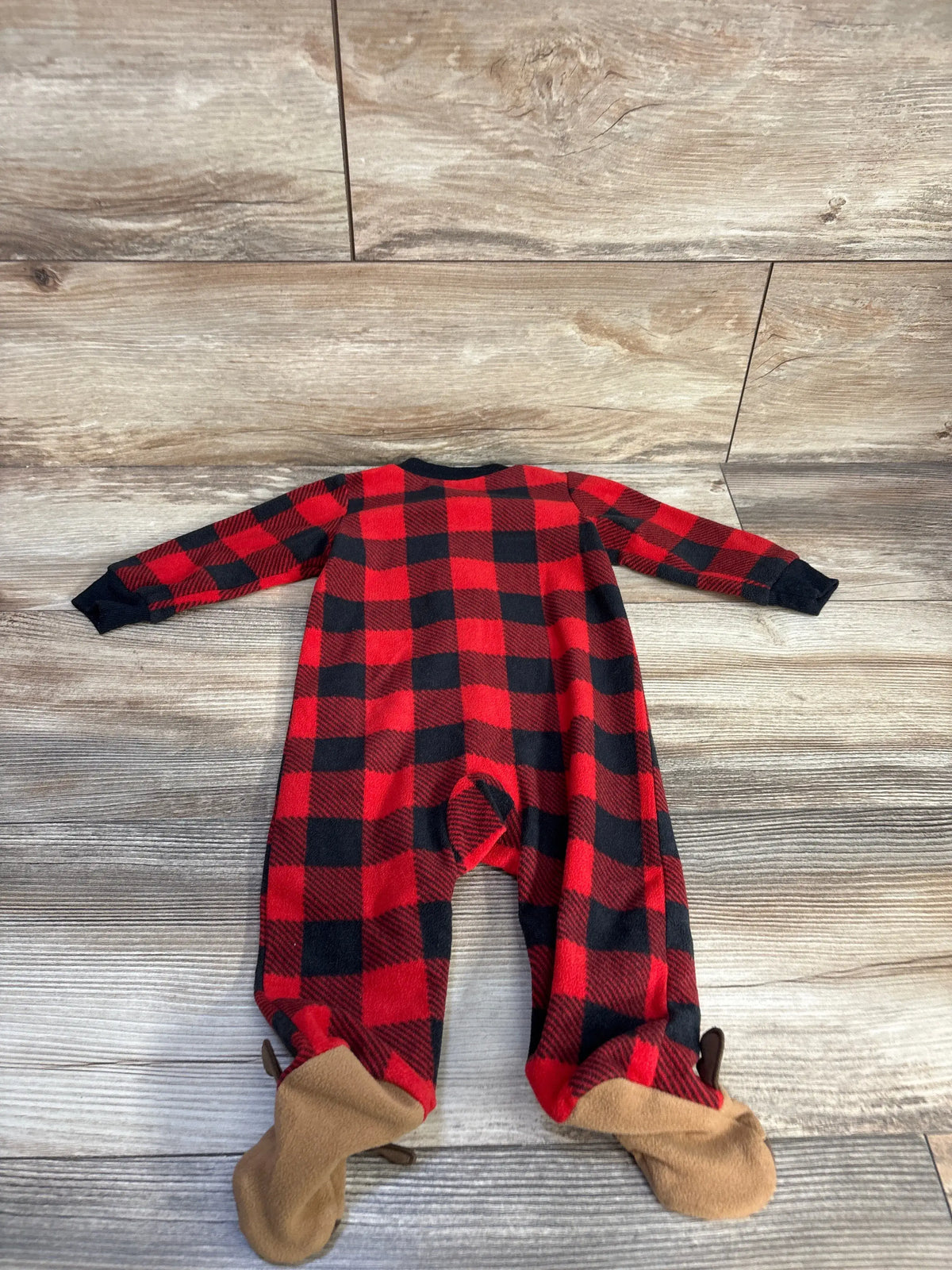 Flat-lay view of Carter’s red and black plaid blanket sleeper showcasing full-length coverage and footed legs on a wood-look floor
