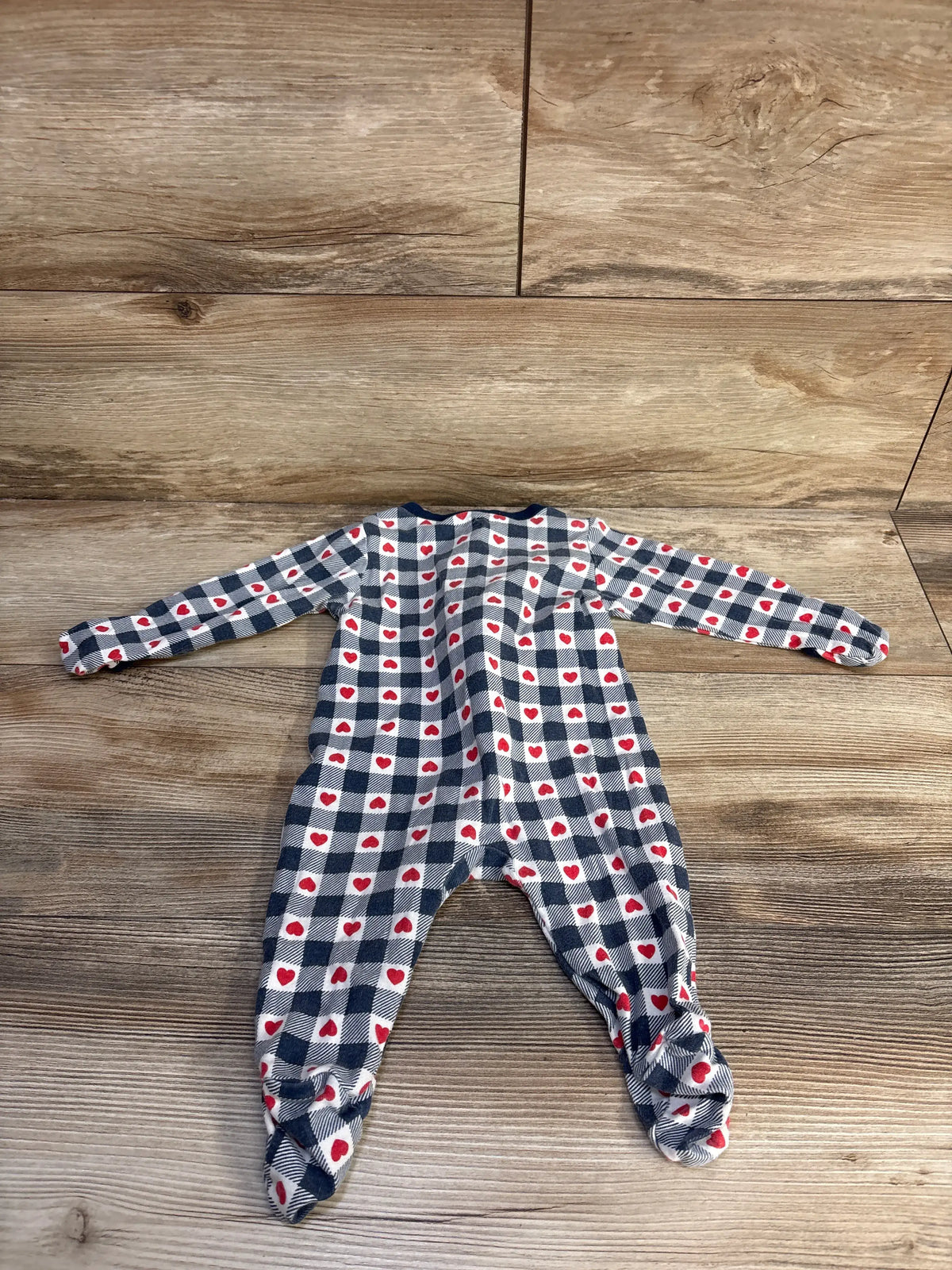 Front view of Old Navy Heart Sleeper Blue sz 3-6m showcasing red hearts on blue-and-white gingham, laid on a wood floor