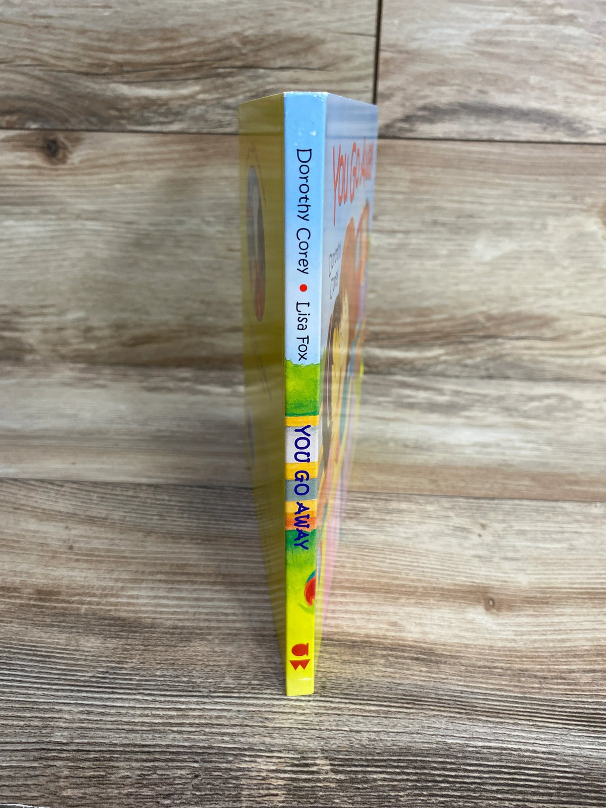 Children's book spine, 'You Go Away' by Dorothy Corey and Lisa Fox, on wood background