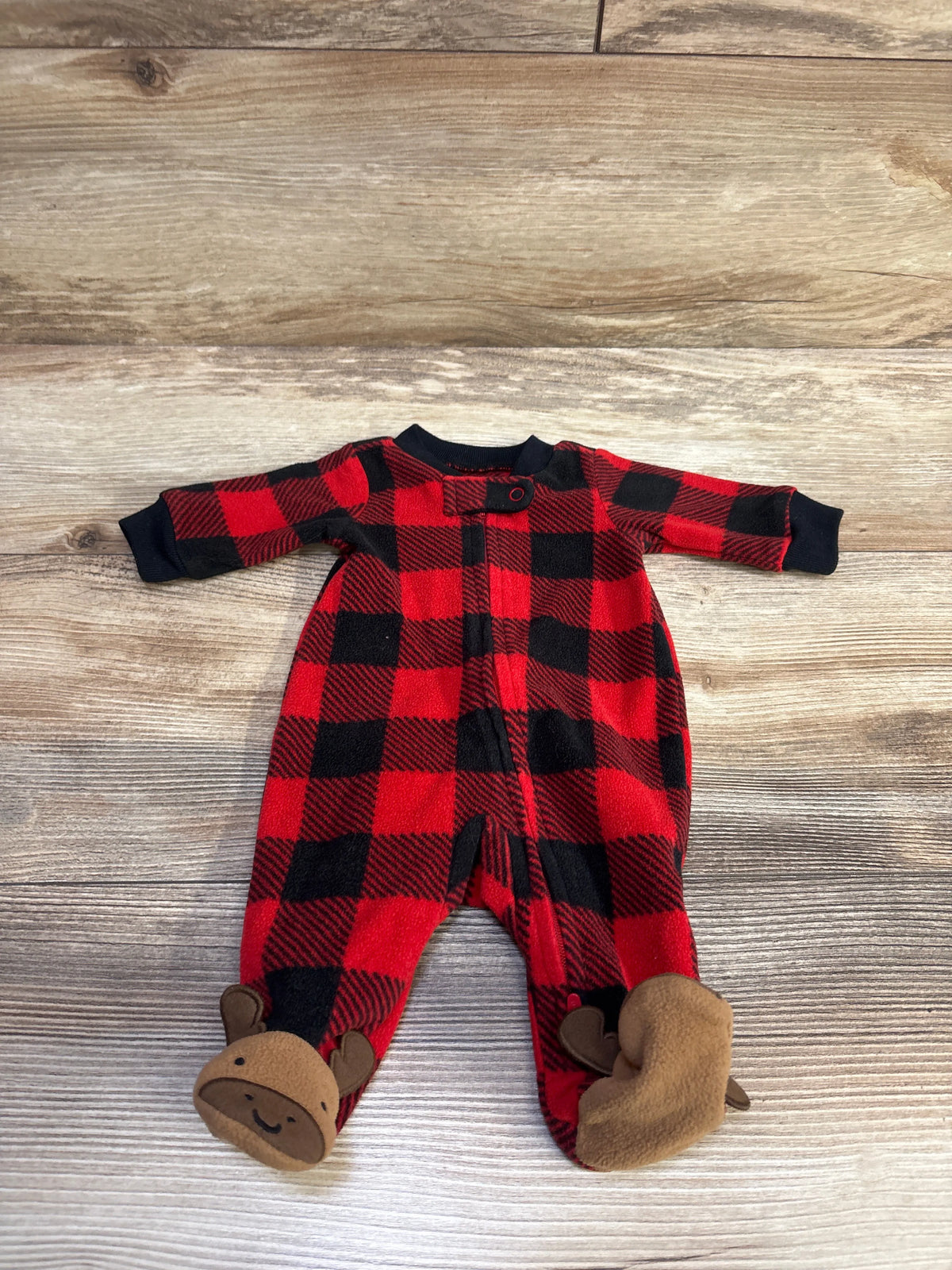 Front view of Carter’s red blanket sleeper showcasing black buffalo plaid, long sleeves, and moose footies on a wood background