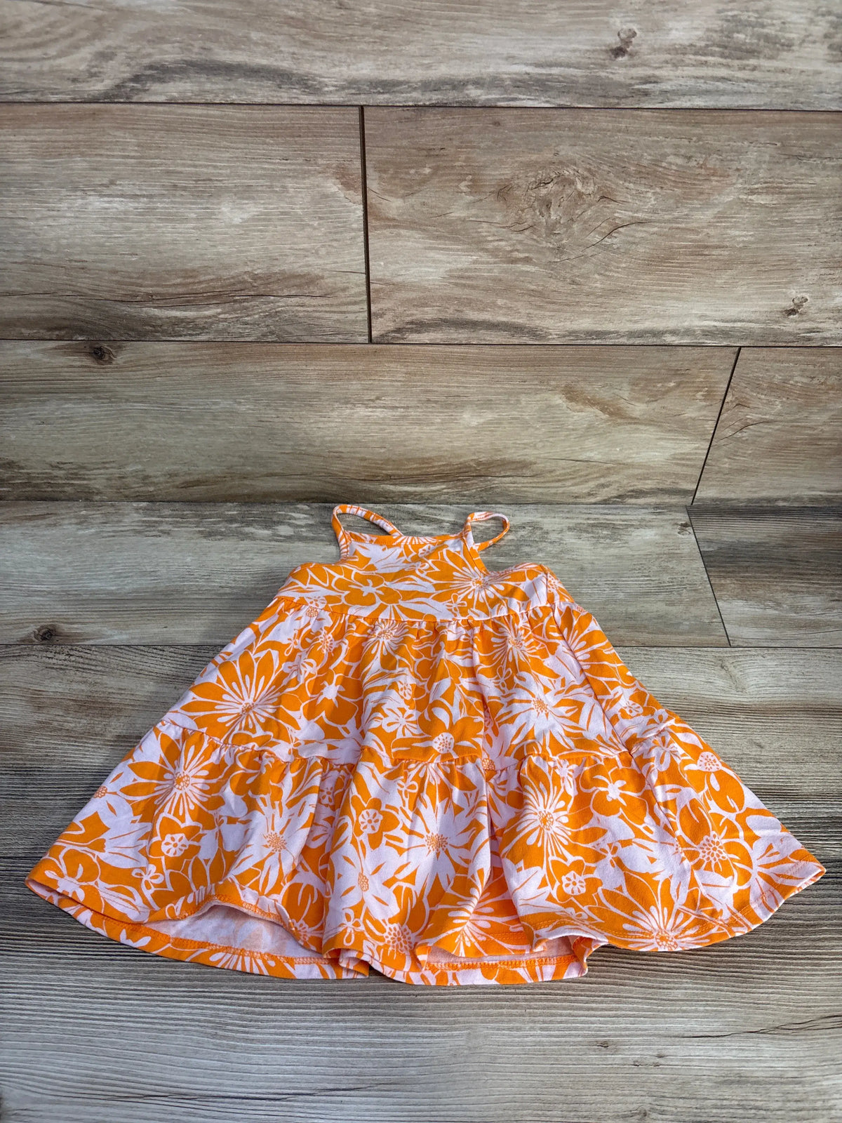 Front view of Cat & Jack orange tank dress in size 2T showcasing spaghetti straps and tiered white floral print skirt on a wood floor