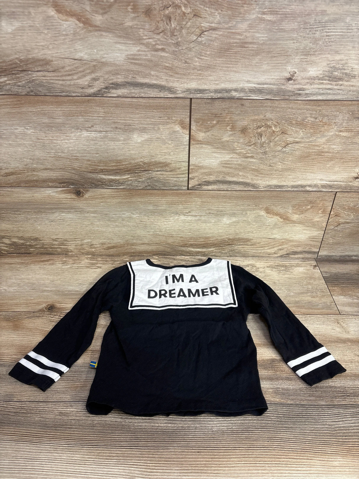 Black long sleeve kids shirt with white stripes and 'I'm a Dreamer' text on back