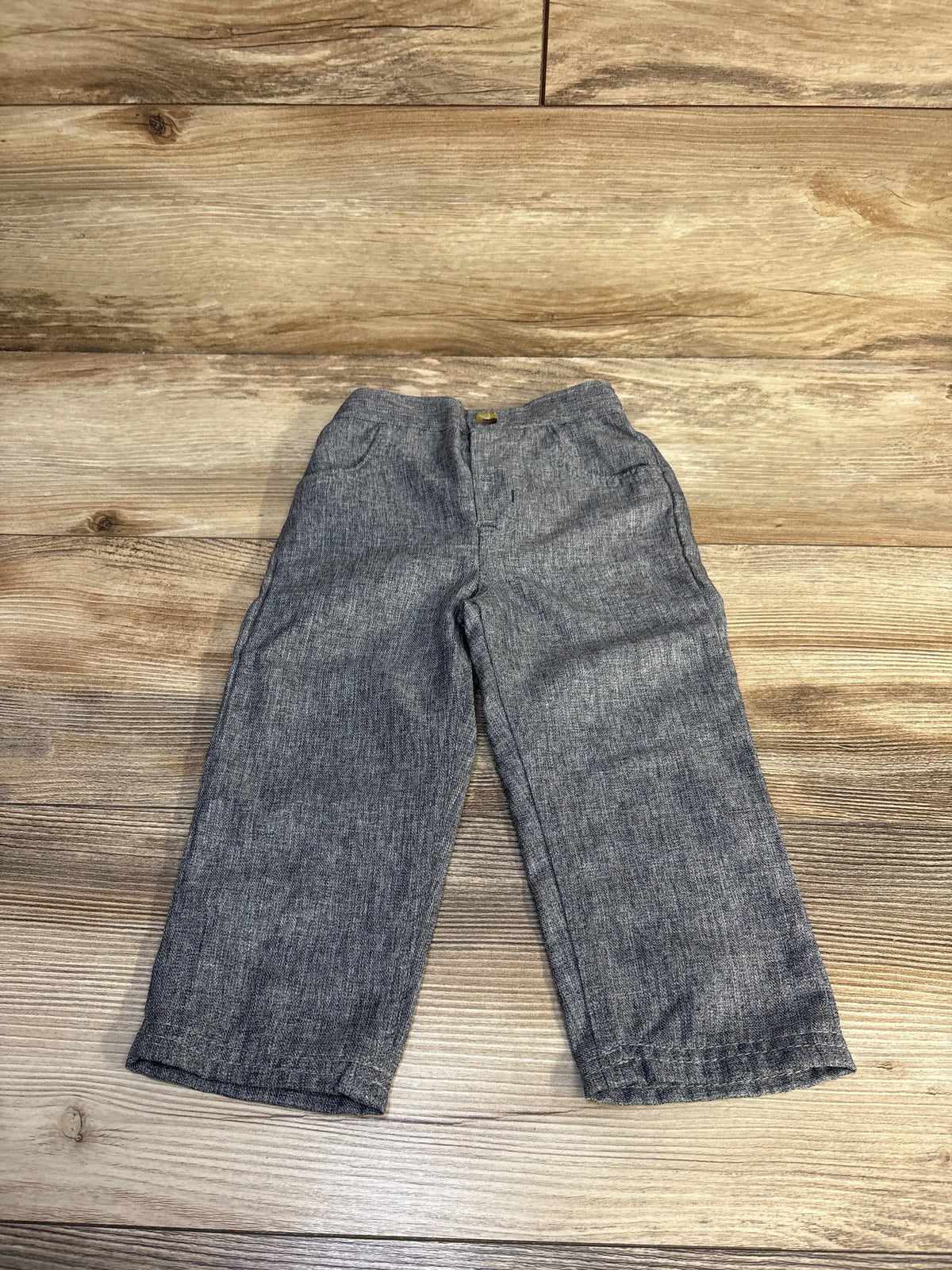 Front view of Tahari grey wide leg pants in size 18 months showcasing relaxed wide leg silhouette on a wood plank background