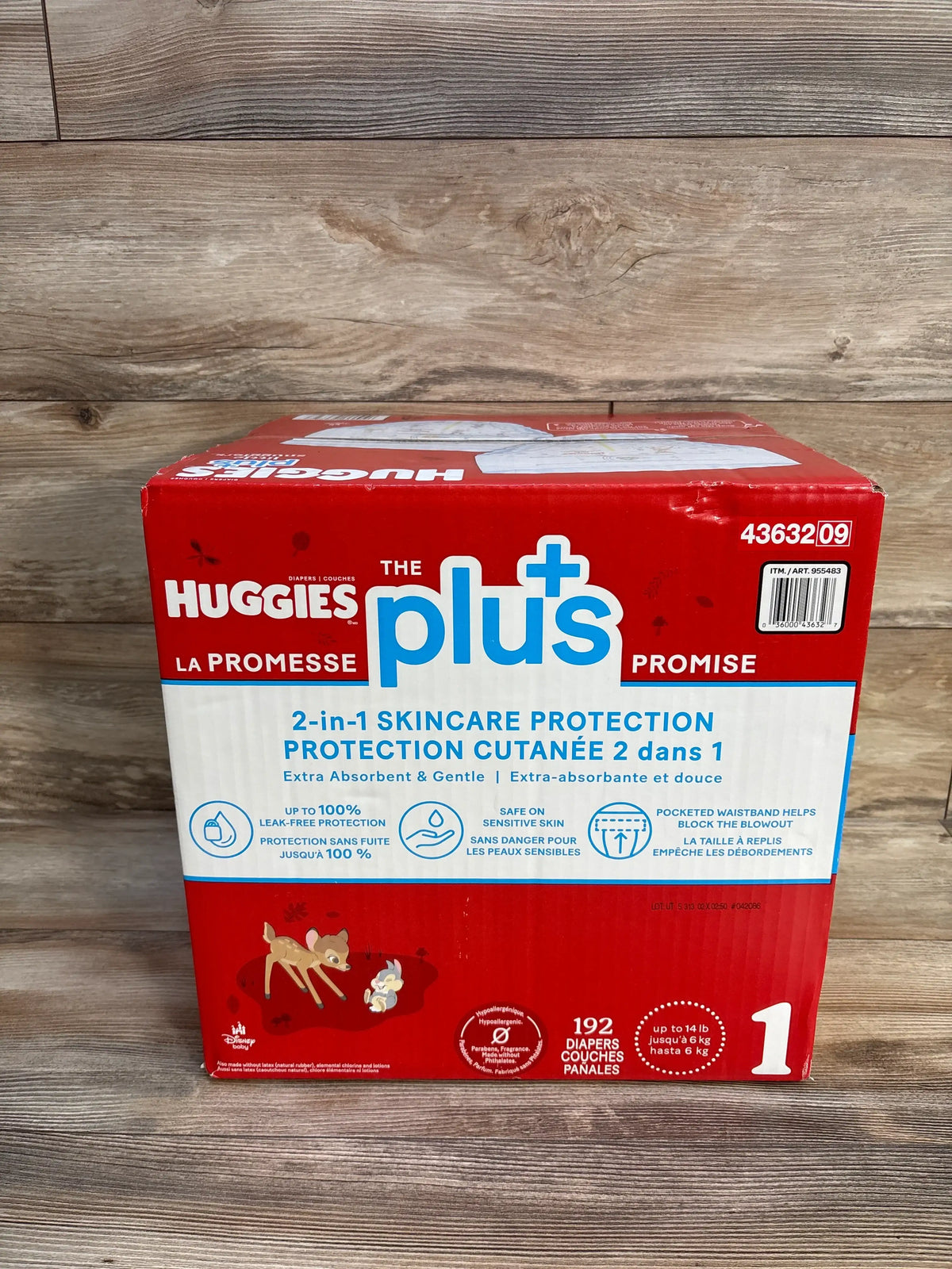 Front view of Huggies Plus Little Snugglers diapers, size 1, 192 count, showcasing two in one skincare protection on wood flooring