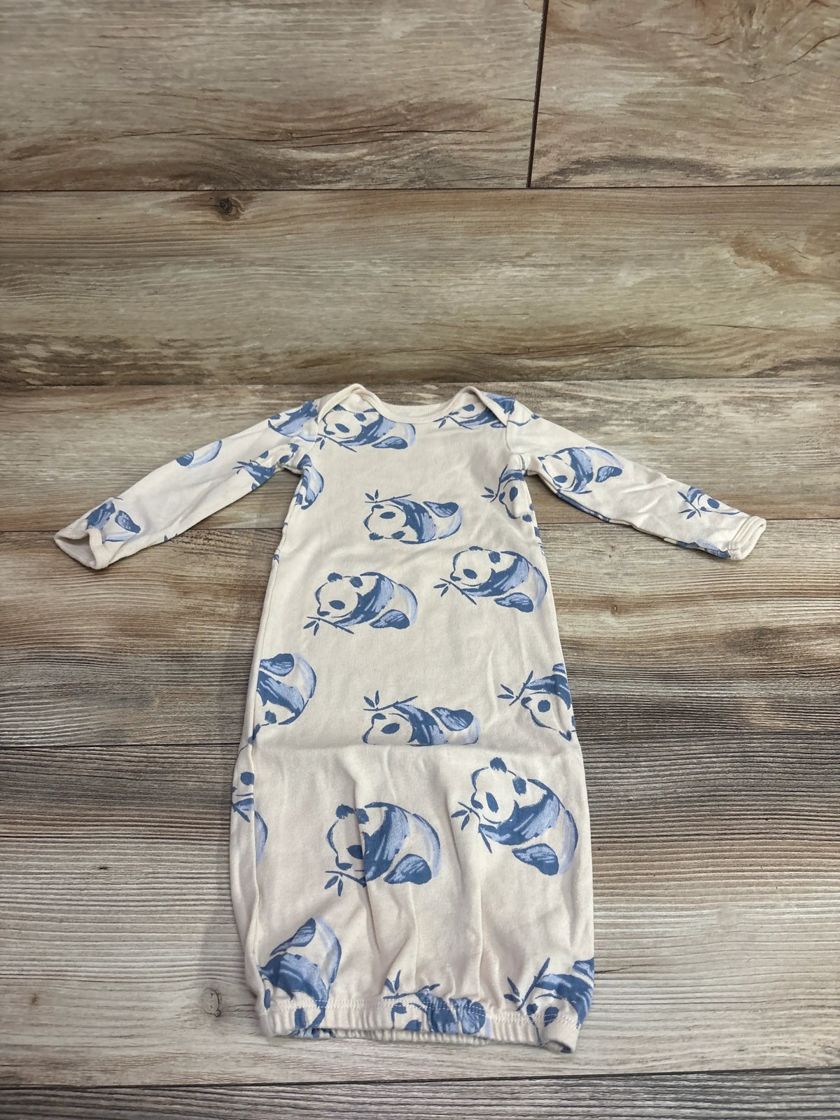 Ivory Carter's panda print baby sleep gown for 3 month olds on a wooden surface
