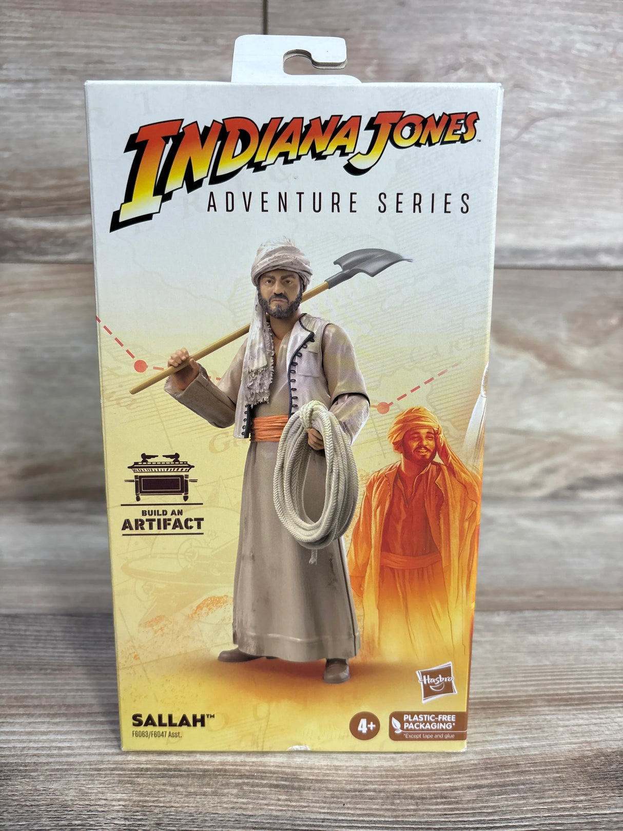 Indiana Jones Adventure Series Sallah action figure box by Hasbro on wood background