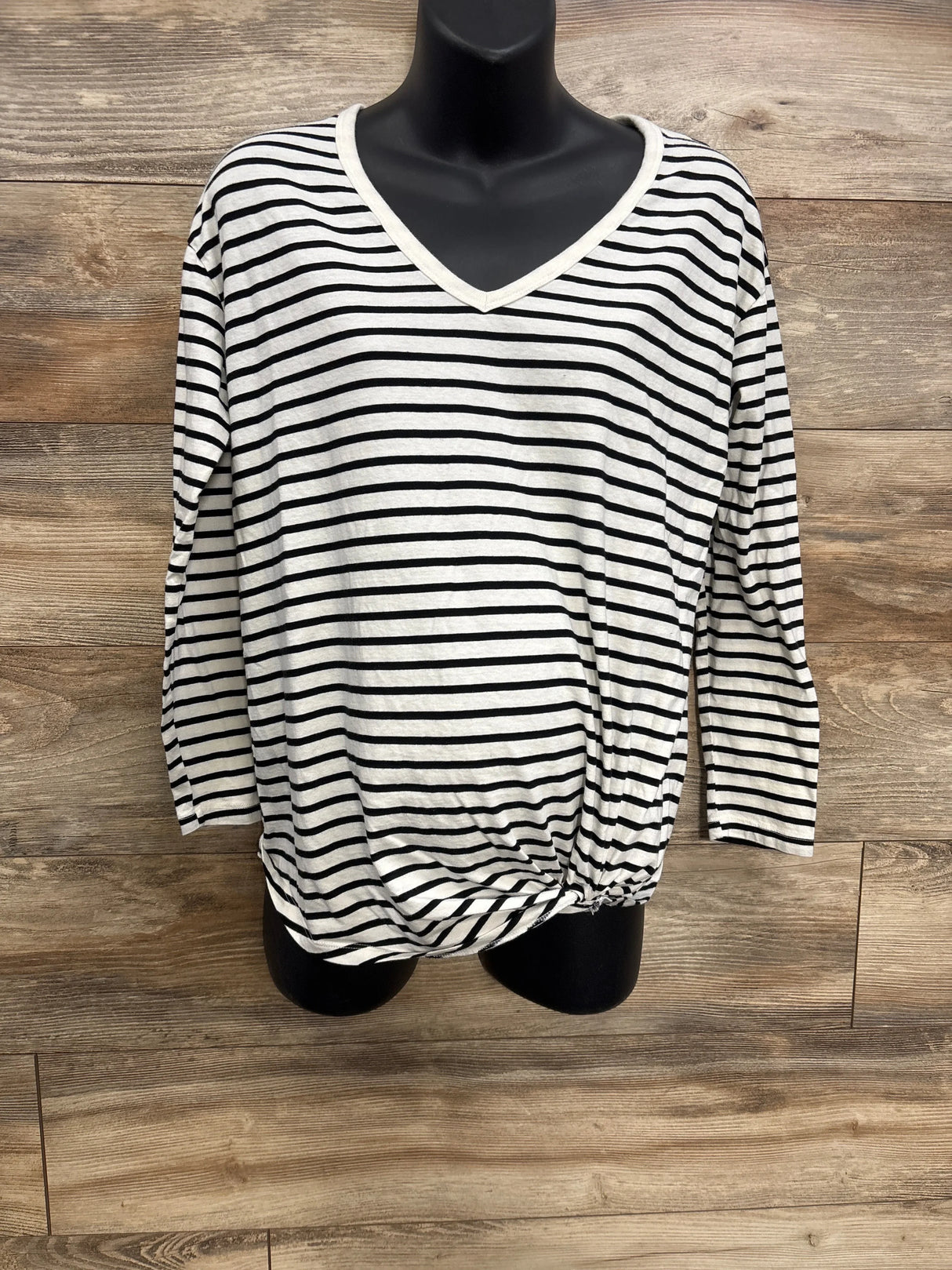 Black and white striped women's V-neck long sleeve shirt on mannequin