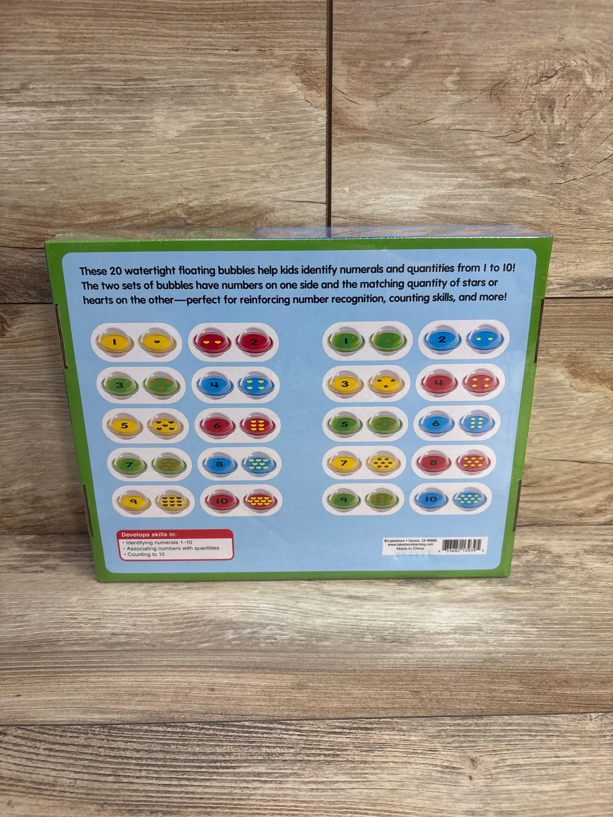 Rear view of Lakeshore Float and Find Number Bubbles showing 20 numbered floating bubble pairs for numbers 1 to 10 on wood backdrop