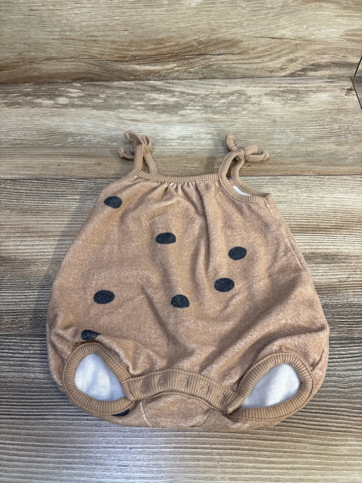 Front view of newborn tan Grayson terry bubble romper with brown dot print on white background