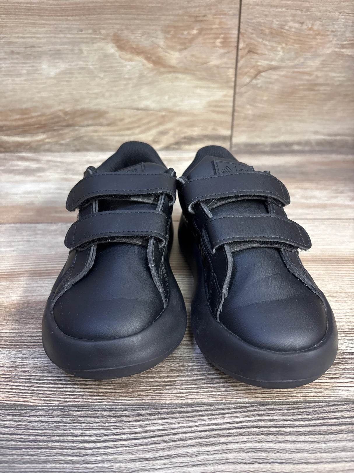 Front view of Adidas x Star Wars Bubblecomfy toddler sneakers showcasing double velcro straps on wood plank background