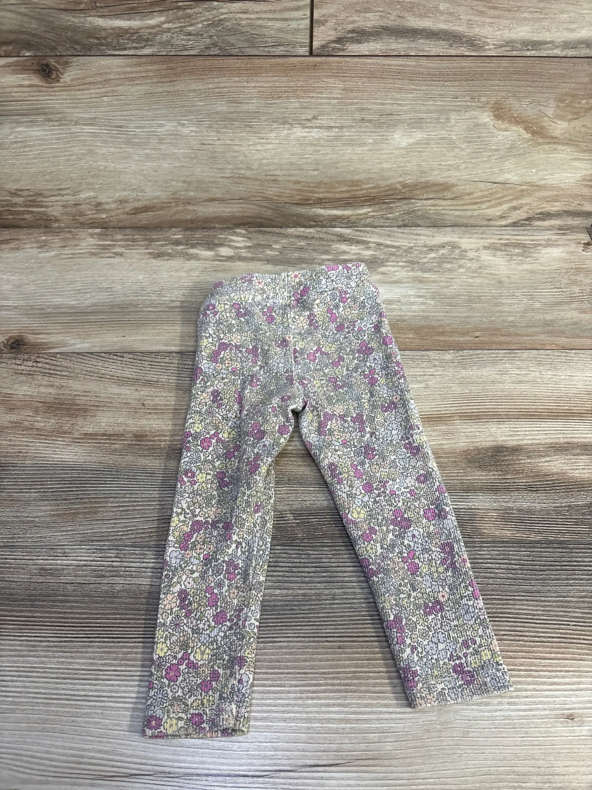 Front view of cream Zara floral ribbed baby leggings showcasing ribbed texture and floral print, size 18 months, on white background