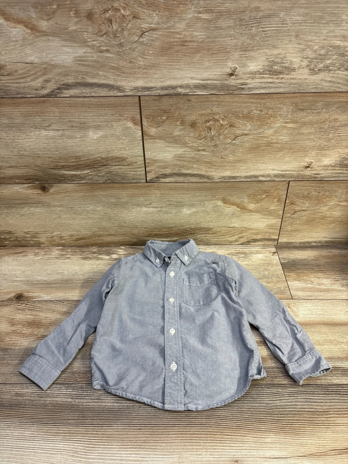 Front view of Children’s Place grey button-down toddler shirt (size 3T) showcasing button-front, button-down collar and chest pocket on wood background