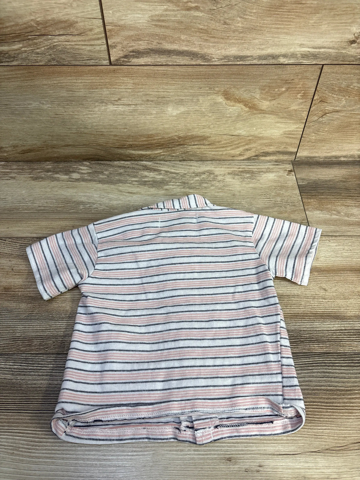 Back view of Ben Sherman striped button-up shirt showcasing pink and dark horizontal stripes on a wooden floor