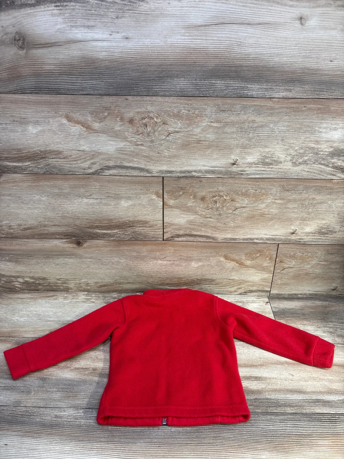 Back view of Columbia red fleece full zip toddler jacket size 3T showing long sleeves and zipper on wood background