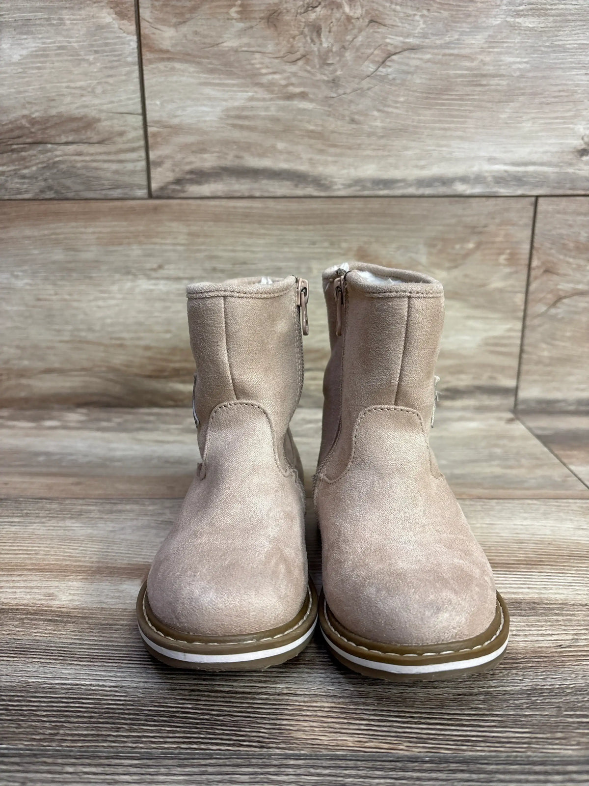 Front view of Cat & Jack Isla suede toddler boots showcasing side zipper and faux-fur lining on wood floor