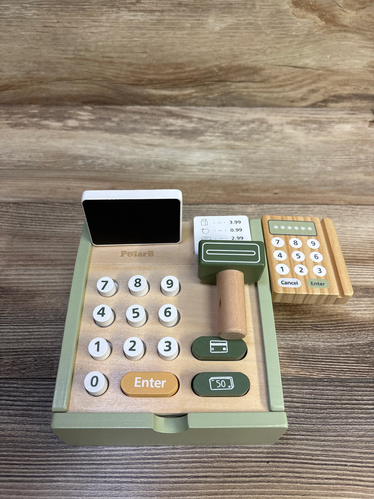 Top-down view of PolarB wooden cash register playset with numbered keypad, wooden scanner and card reader on wood table