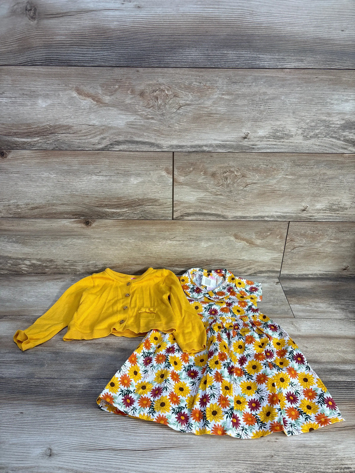 Flat lay of Goodlad 2pc floral dress and cardigan set in size 24 months with yellow cardigan and floral dress