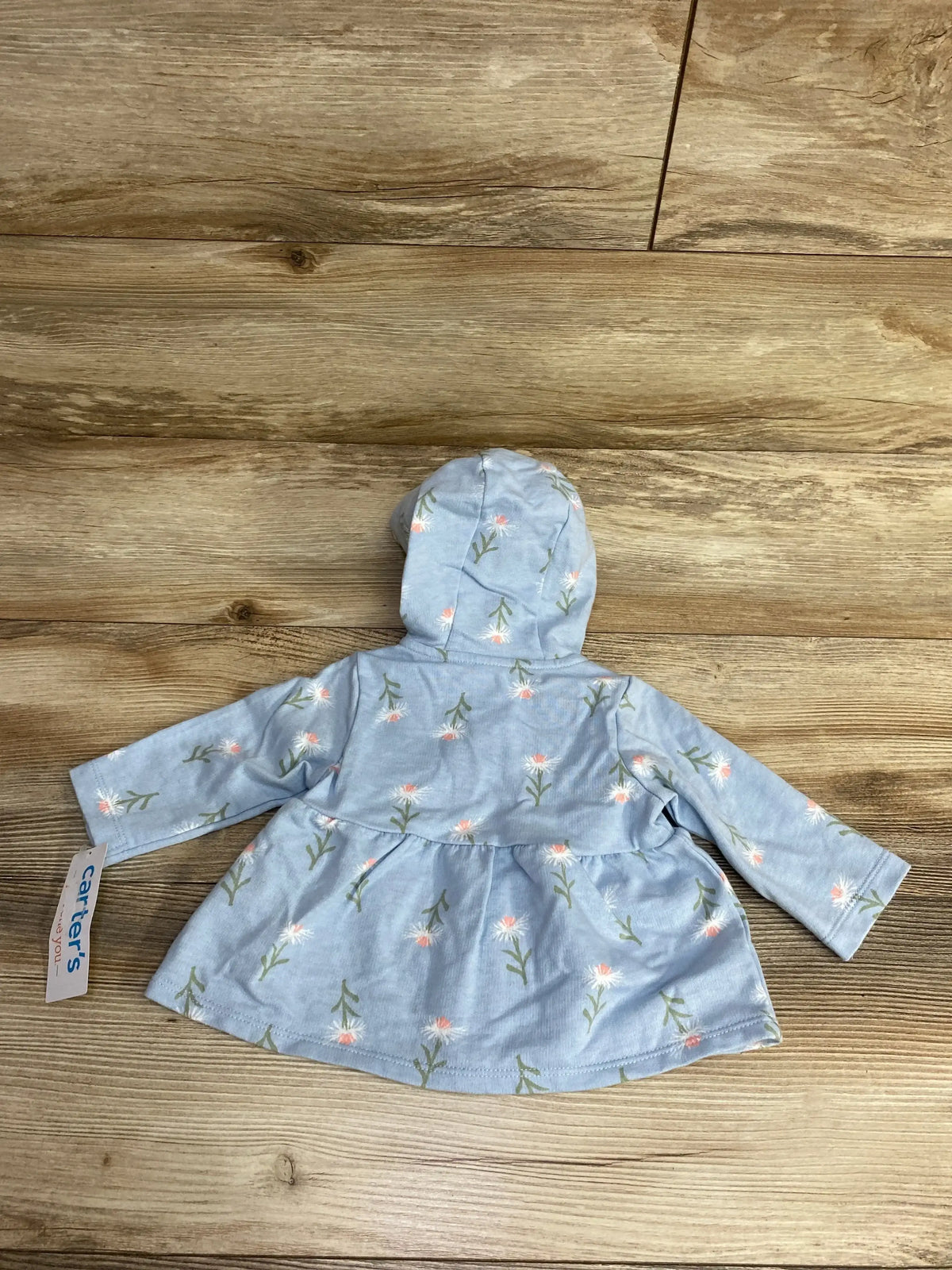 Light blue baby hoodie dress with pink floral print from Carter's, displayed on wood surface