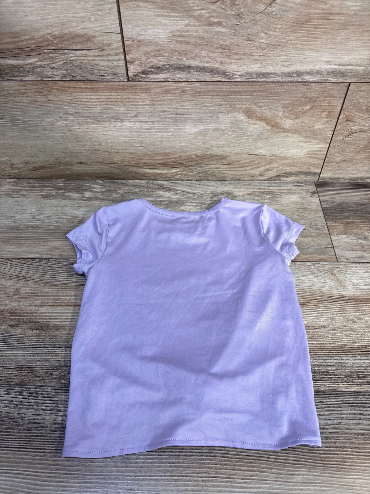 Front view of Skechers California shirt in purple size 3T showcasing short sleeves and relaxed fit on a wood floor
