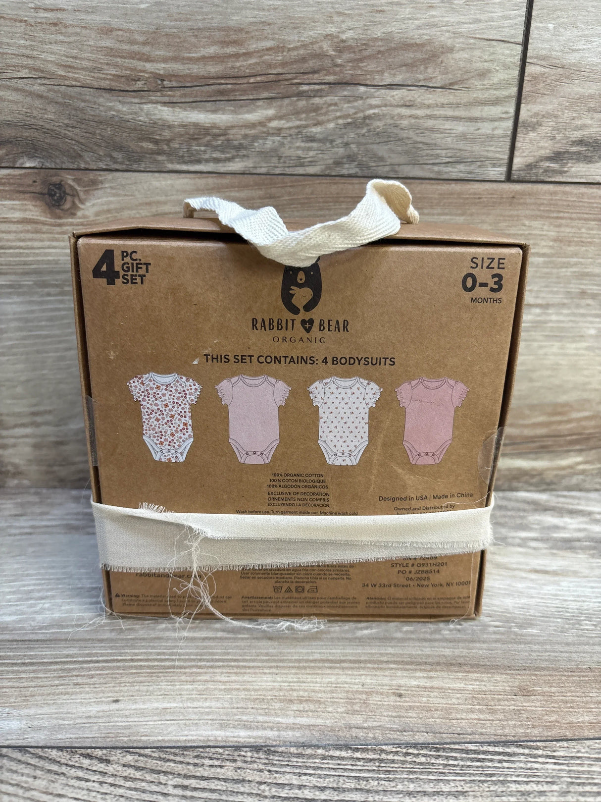 Rabbit & Bear Organic baby bodysuits 4-piece gift set, size 0-3 months, boxed on wood background