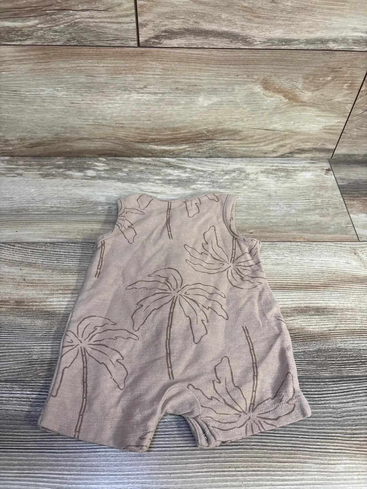Front view of Just One You Henley shortie romper with brown palm tree print and henley neckline