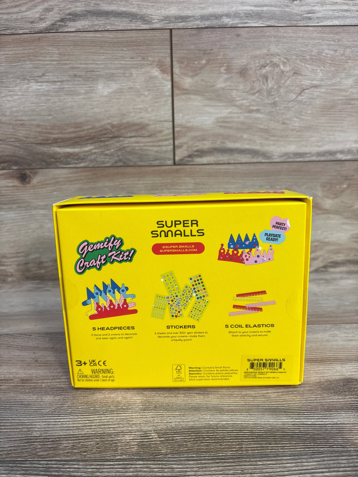 Super Smalls Gemify Craft Kit box with headpieces, stickers, coil elastics on wood background