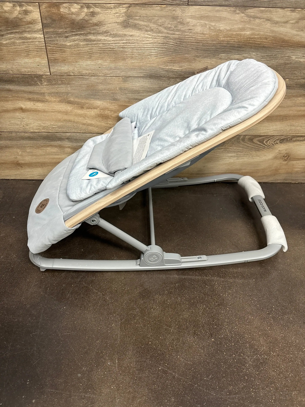 Side view of Maxi-Cosi Kori 2-in-1 rocker in classic slate showing padded reclined seat, wood-look trim and gray frame
