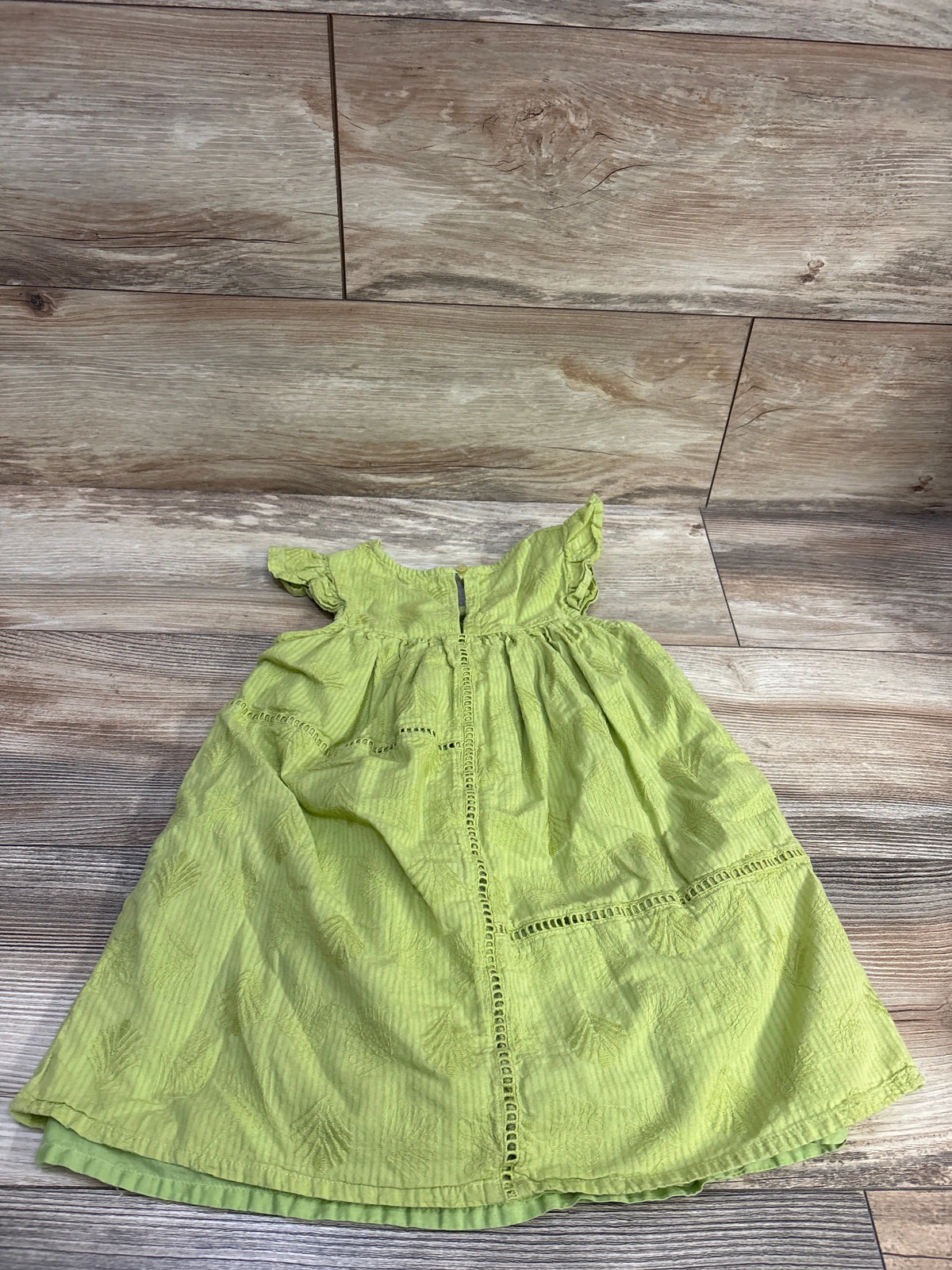 Front view of Mayoral apple green sleeveless dress in size 4T with embroidery, ruffled shoulders, and decorative trim