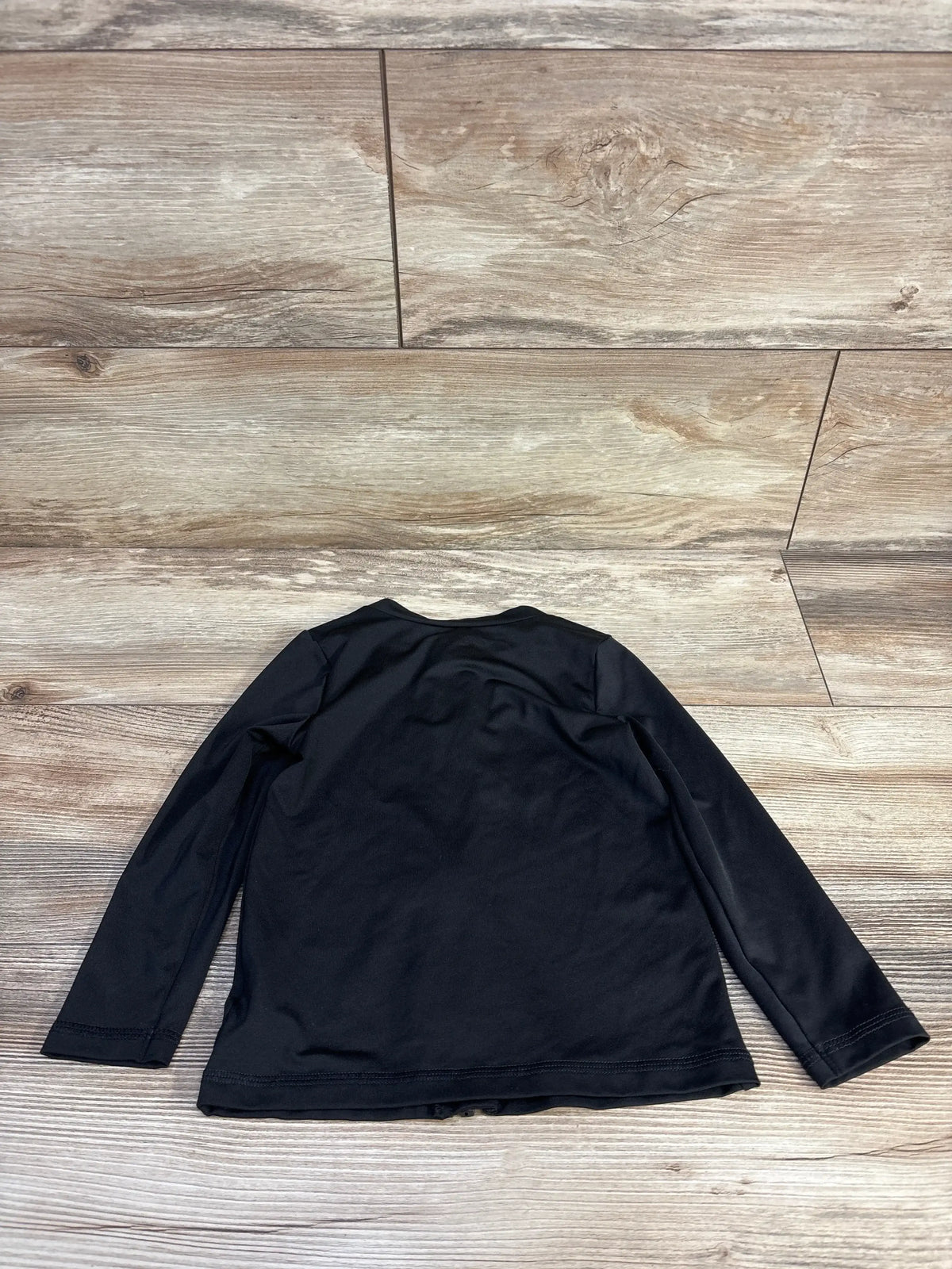 Back view of Cat & Jack black toddler full-zip long-sleeve rash guard, size 3T, flat laid on wood floor