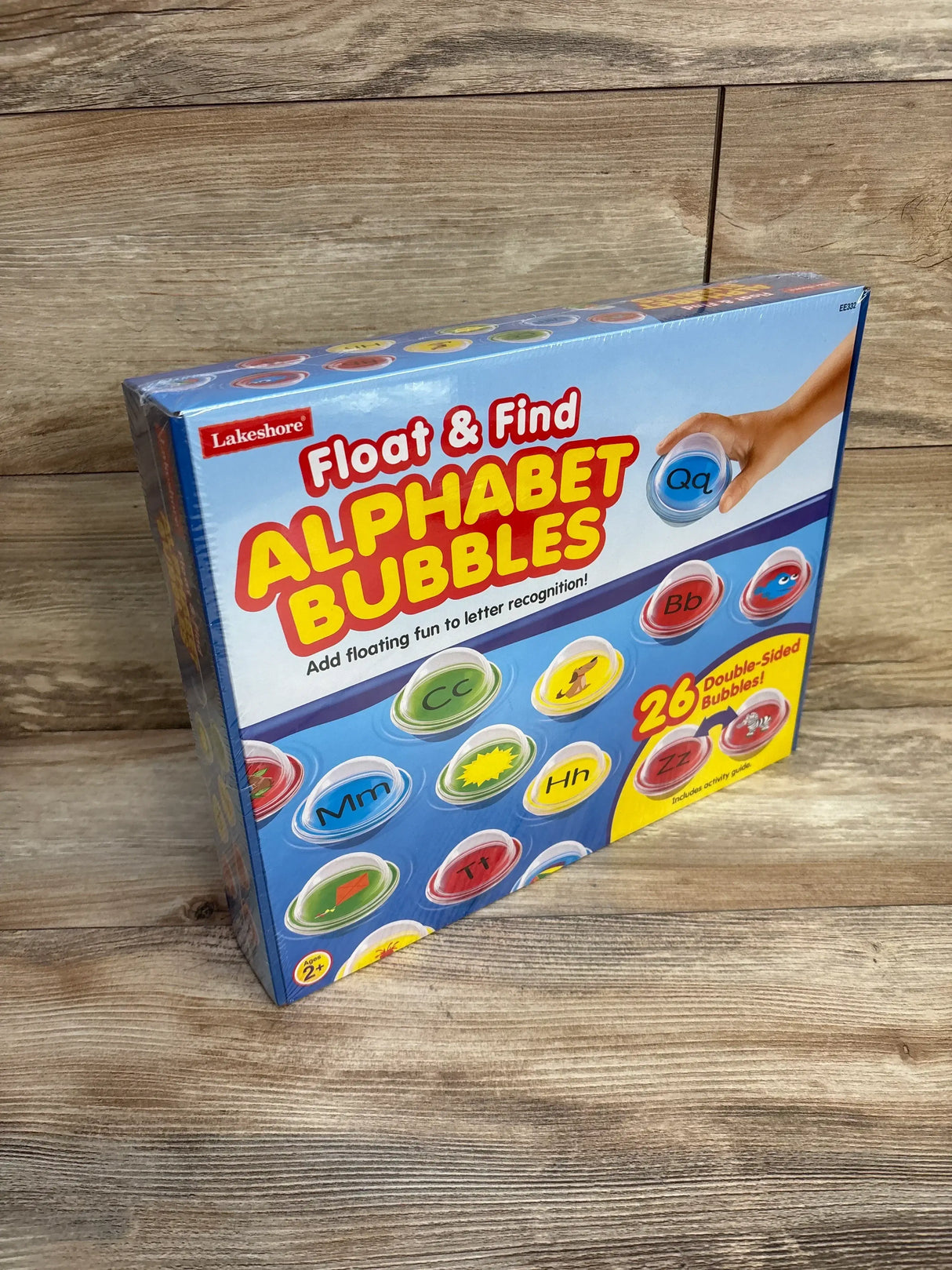 Front-right view of Lakeshore Alphabet Bubbles box showing colorful letter bubbles and 26 double sided bubbles text on wood